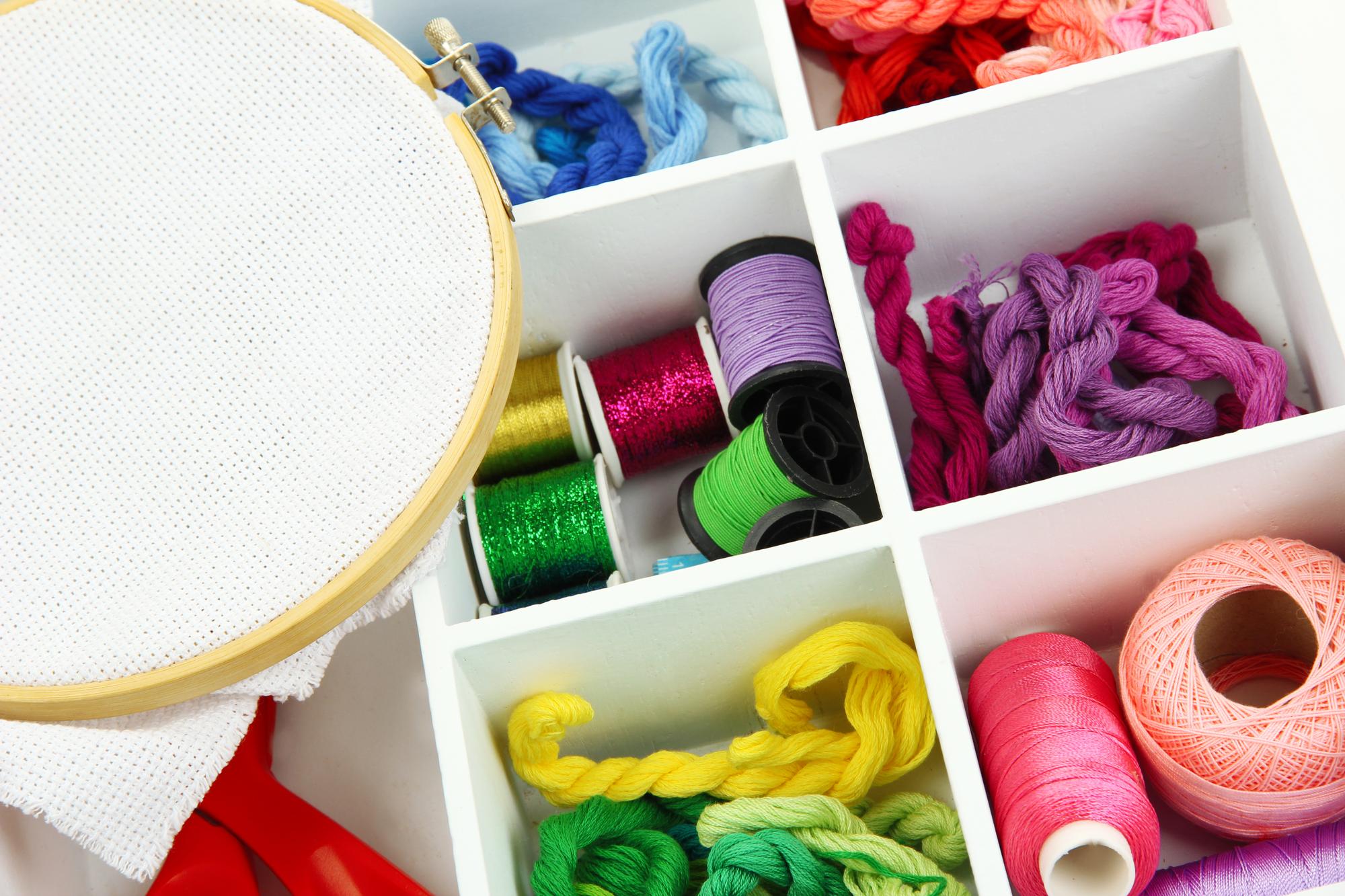 Studio workspace with hoops and threads