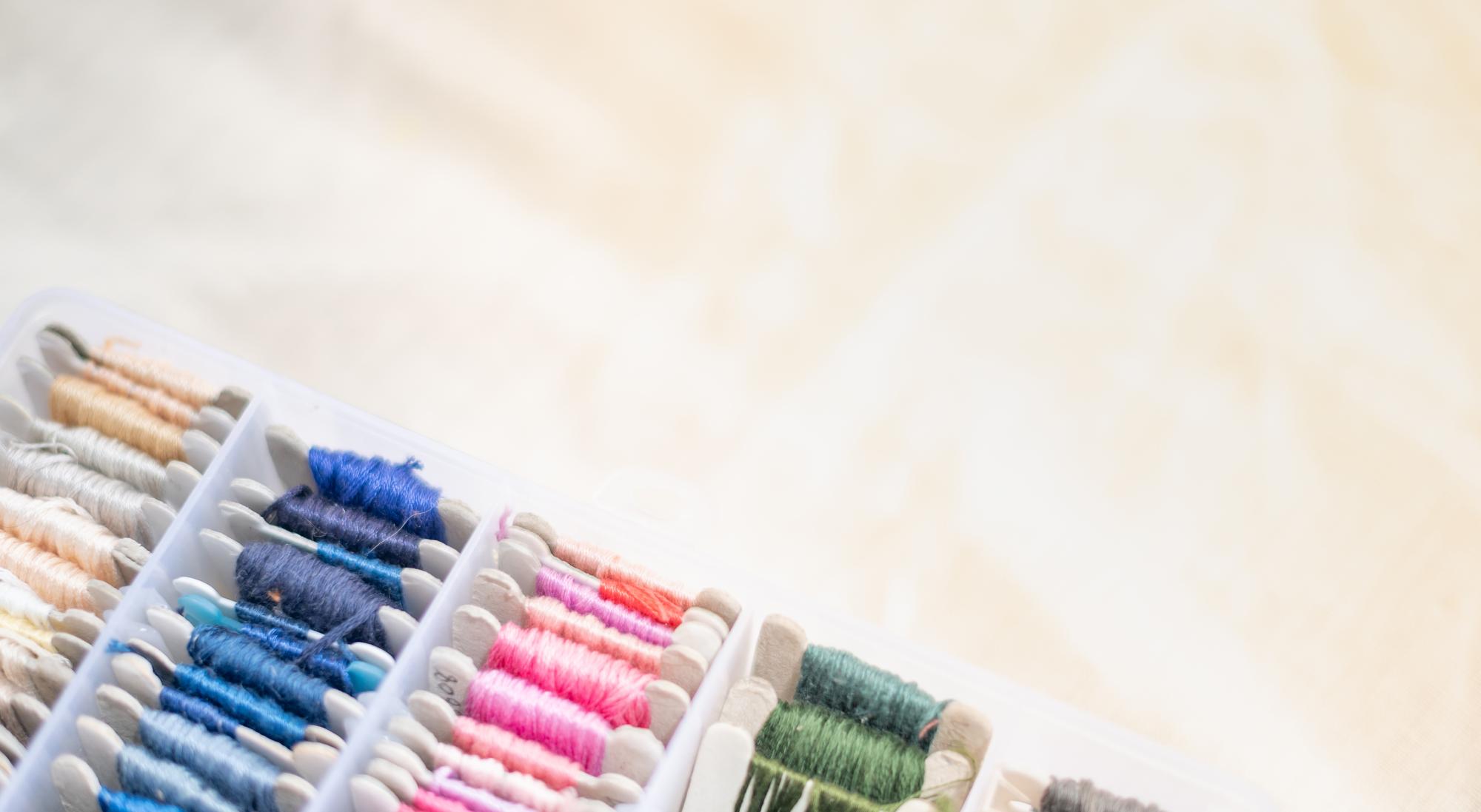 Stacked embroidered samples on table